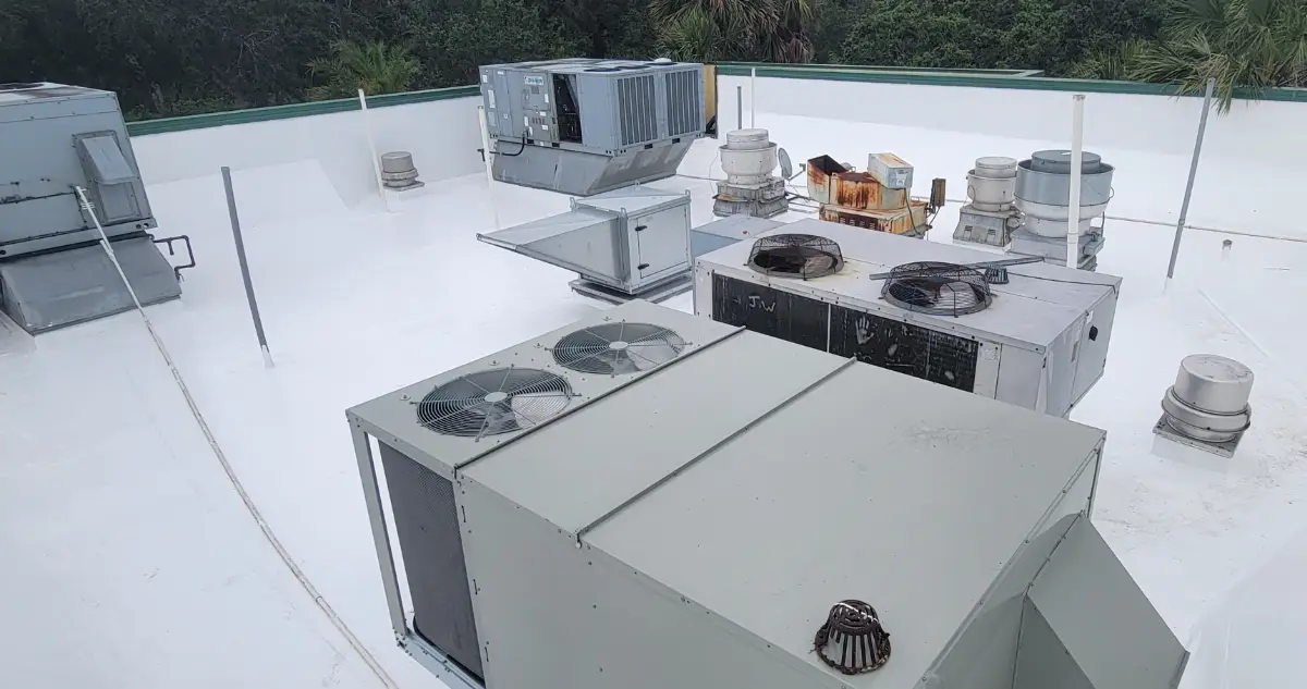 Commercial flat roof in Pennsylvania restored with a high-reflectance white roof coating, showing rooftop HVAC units on a bright, reflective surface.