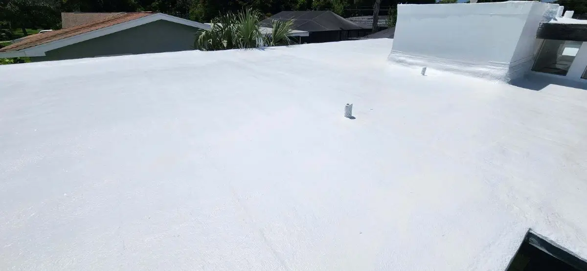 do-roof-coatings-impact-captured-rainwater-pennsylvania Freshly applied white roof coating on a low-slope roof, demonstrating a reflective roof restoration system that may be used on residential or commercial buildings.