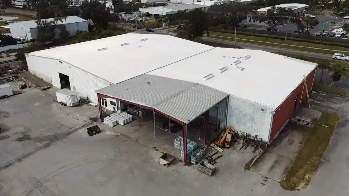 commercial-roof-coating-tax-deduction-section-179 White reflective coating installed on a commercial roof that may qualify for business tax treatment under applicable IRS rules.