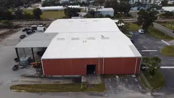 Commercial factory roof restored with a white reflective Conklin roof coating system.