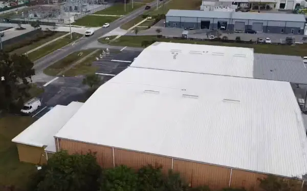 Aerial view of a factory with a white Conklin reflective coating protecting the existing commercial roof.
